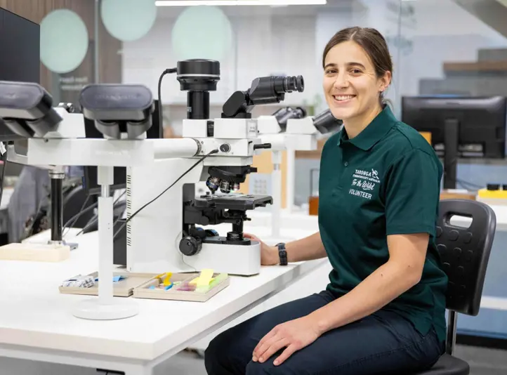 Lab Volunteer sitting at desk with equipment