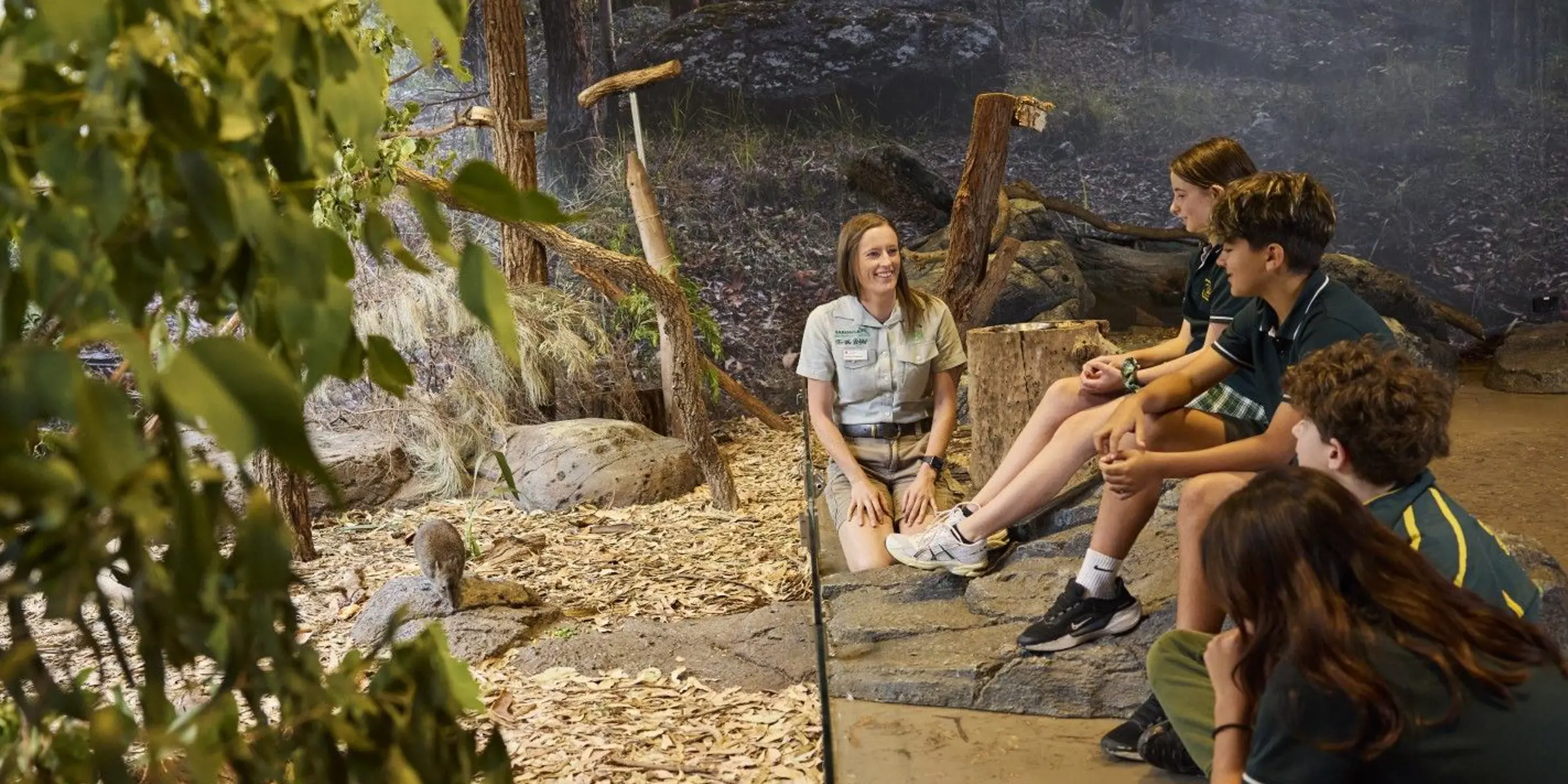 Taronga educator in bushland habitat classroom with school kids teaching them about Potoroos