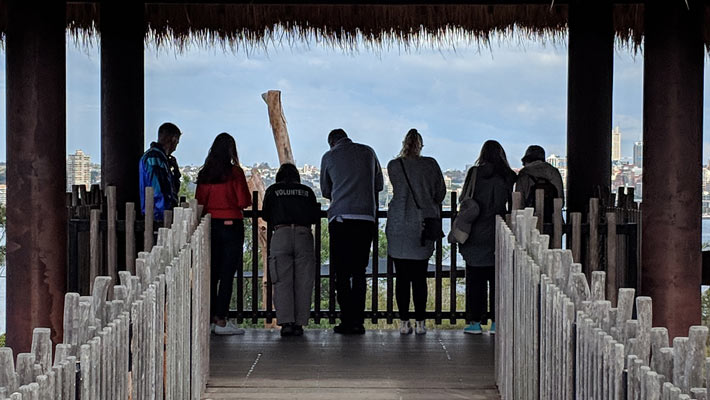 Volunteers and guests overlook an exhibit