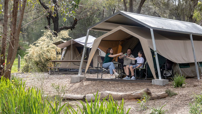 Family relaxing at their Billabong Camp tent