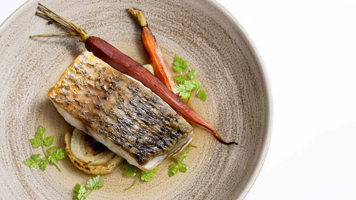 Delectable Coral coast barramundi, with confit fennel, chat potatoes, Dutch carrots and dashi broth.