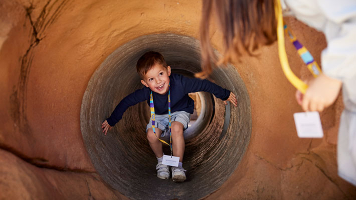 Child climbing through tunnel